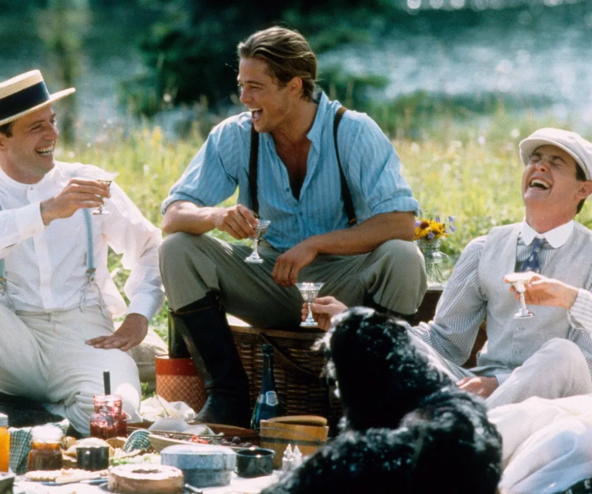 The Ludlow brothers are laughing on the grass enjoying a picnic with champagne in the film Legends Of The Fall