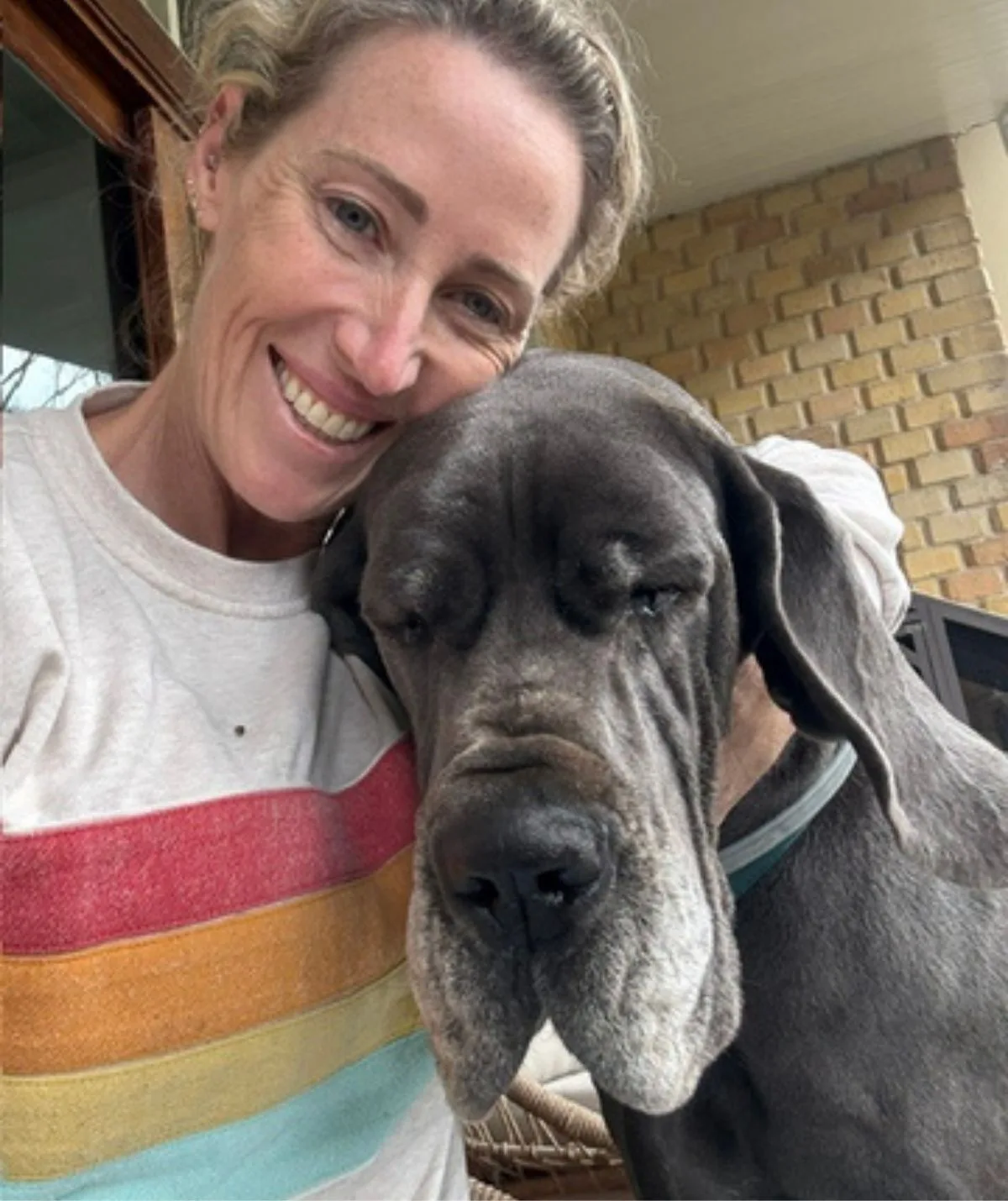Jana Pittman smiling next to her dog