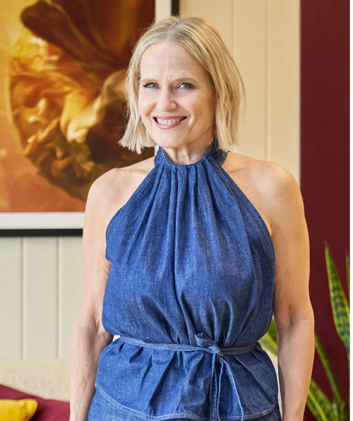 Shaynna Blaze in a denim dress smiling 