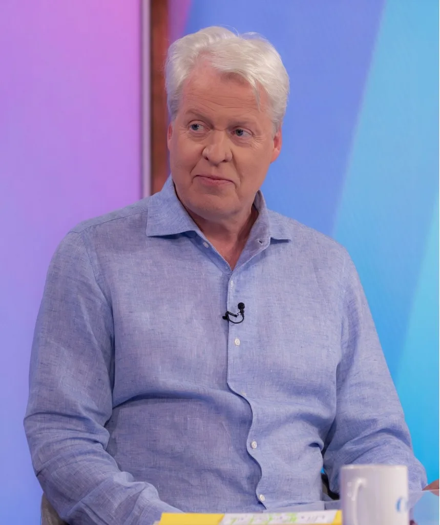 Charles Spencer in a blue shirt promoting his book on British TV