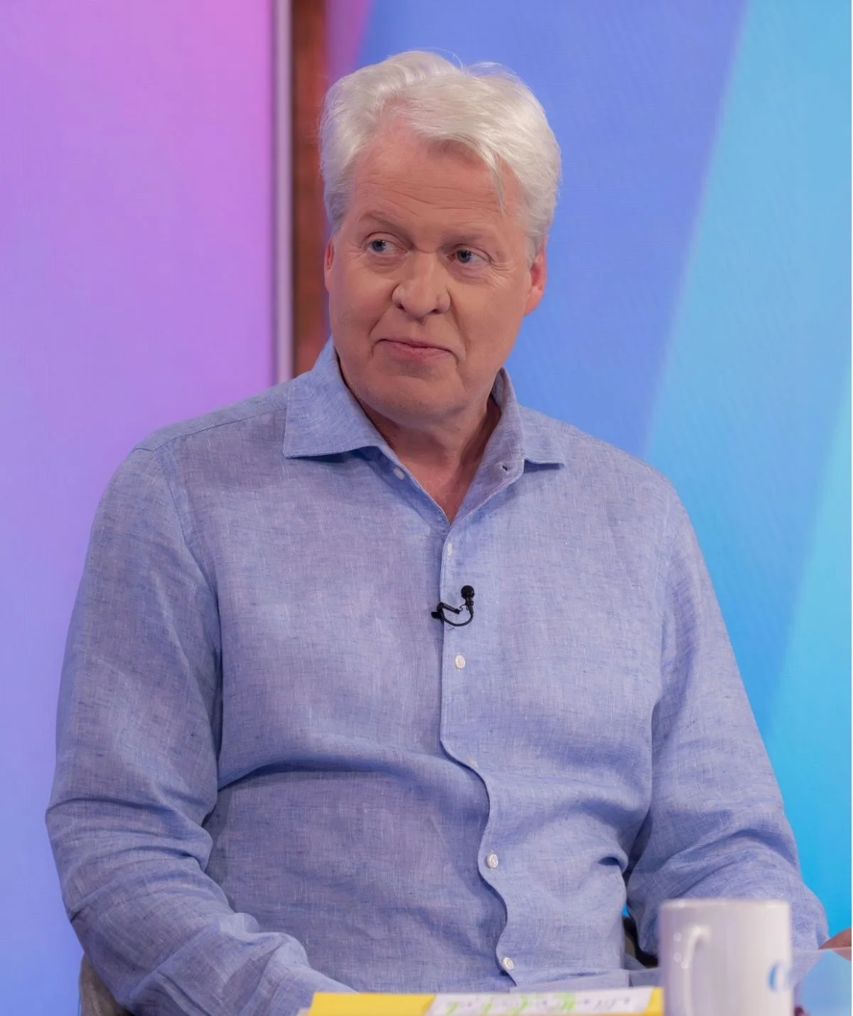 Charles Spencer in a blue shirt promoting his book on British TV