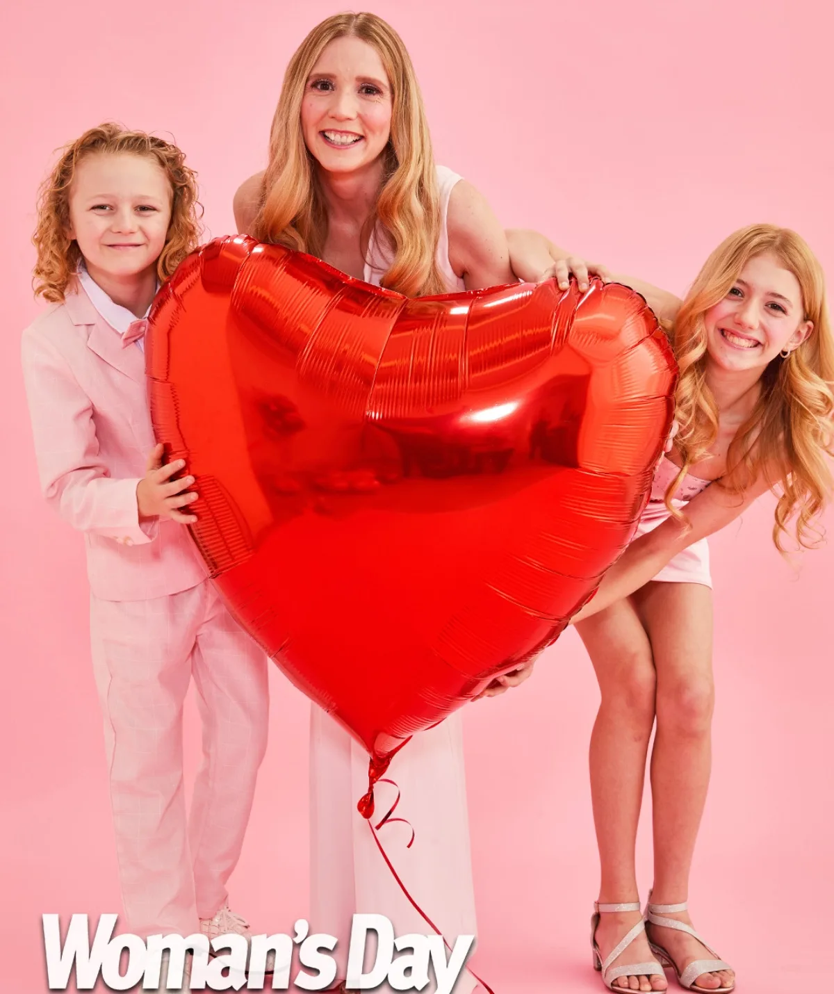 Nikki Webster and her kids holding a red heart balloon 