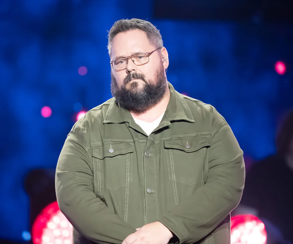 Dicko, in an olive shirt, on the set of The Voice