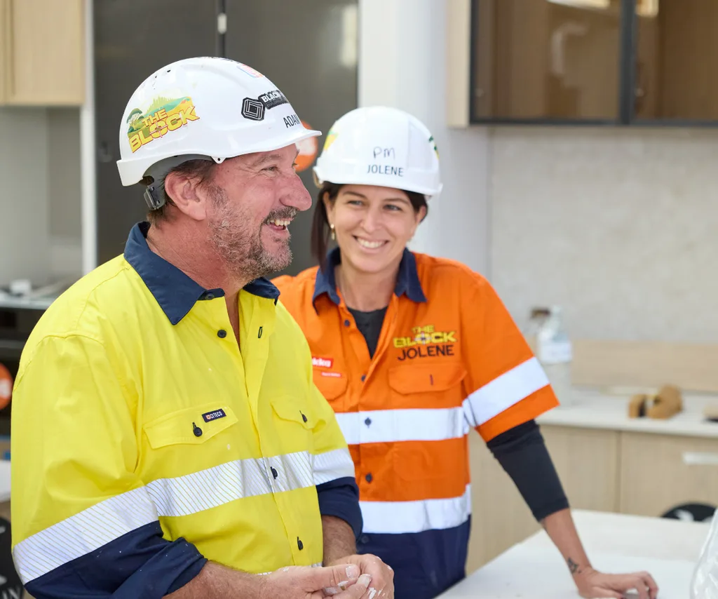Adam and Jolene from The Block on site in hi-vis.