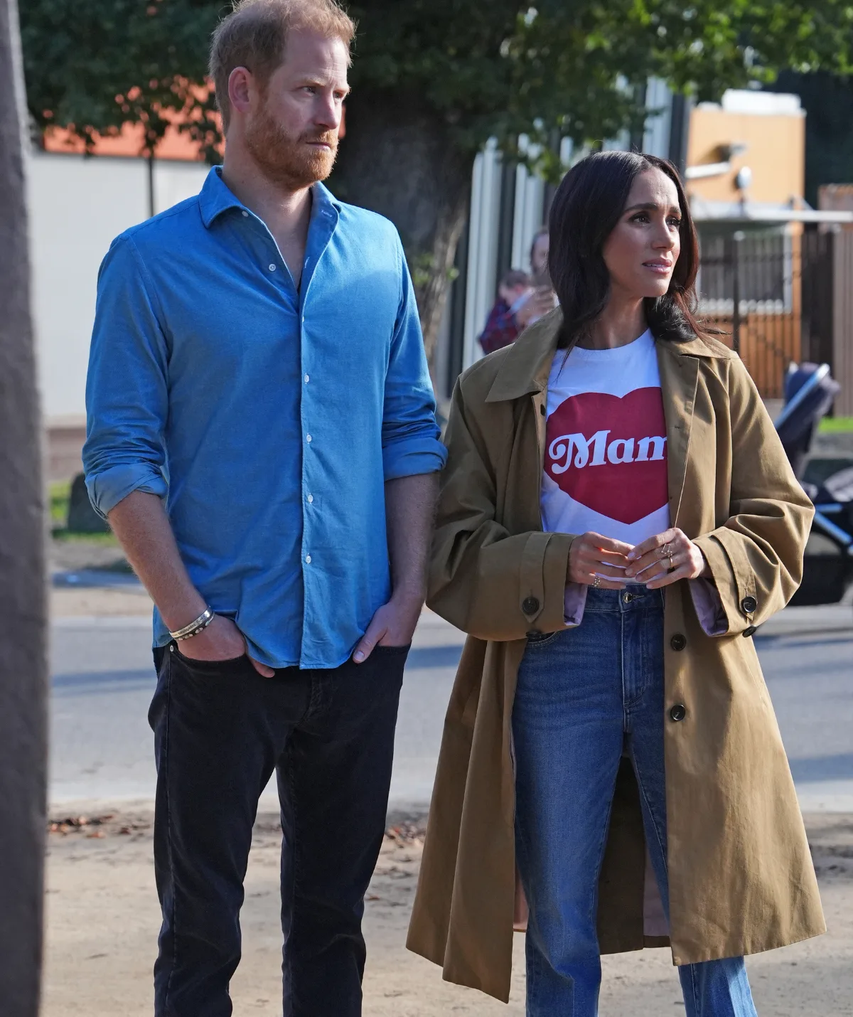 Prince Harry and Meghan Markle, with Harry hands in pockets