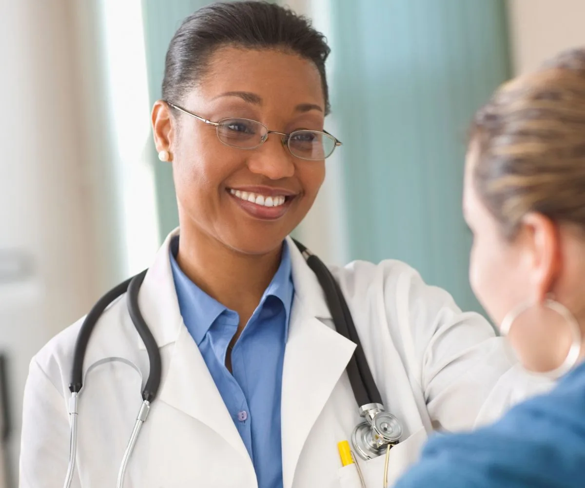 Female doctor smiling while talking to a patient