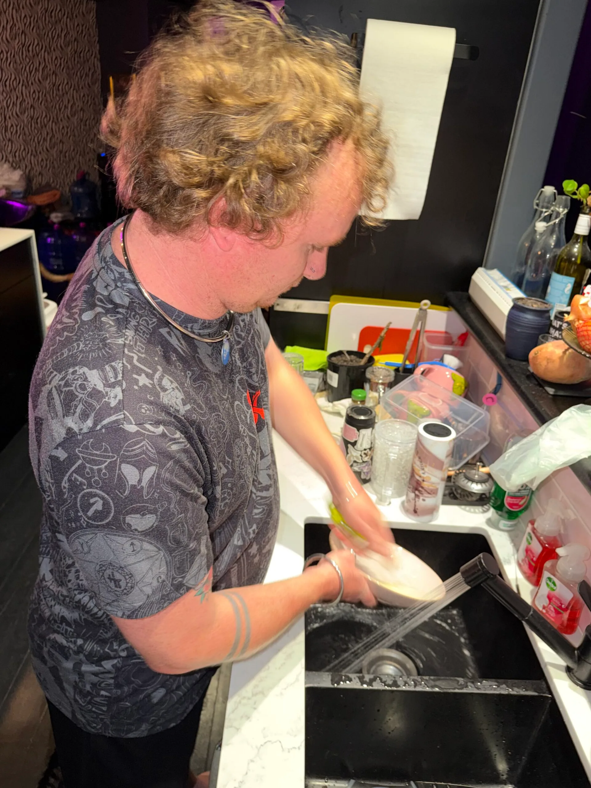 Sub Bradley at his dominatrix master Sarah Button's house, washing her dishes