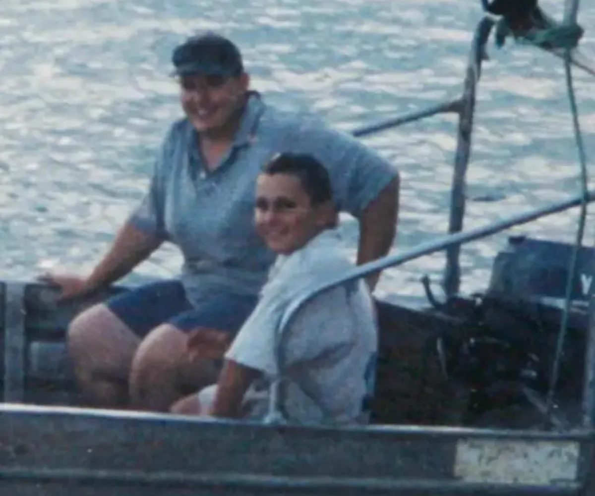 Bevin and Brad Simmonds in a small boat at sea.