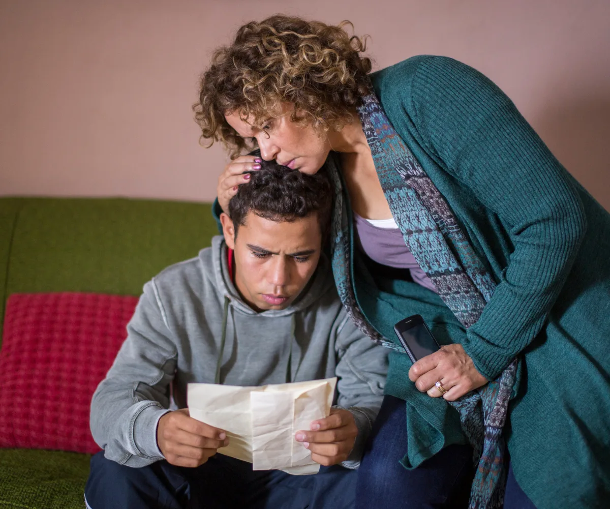 Leah kisses a young actor's head on the set of Redfern Now