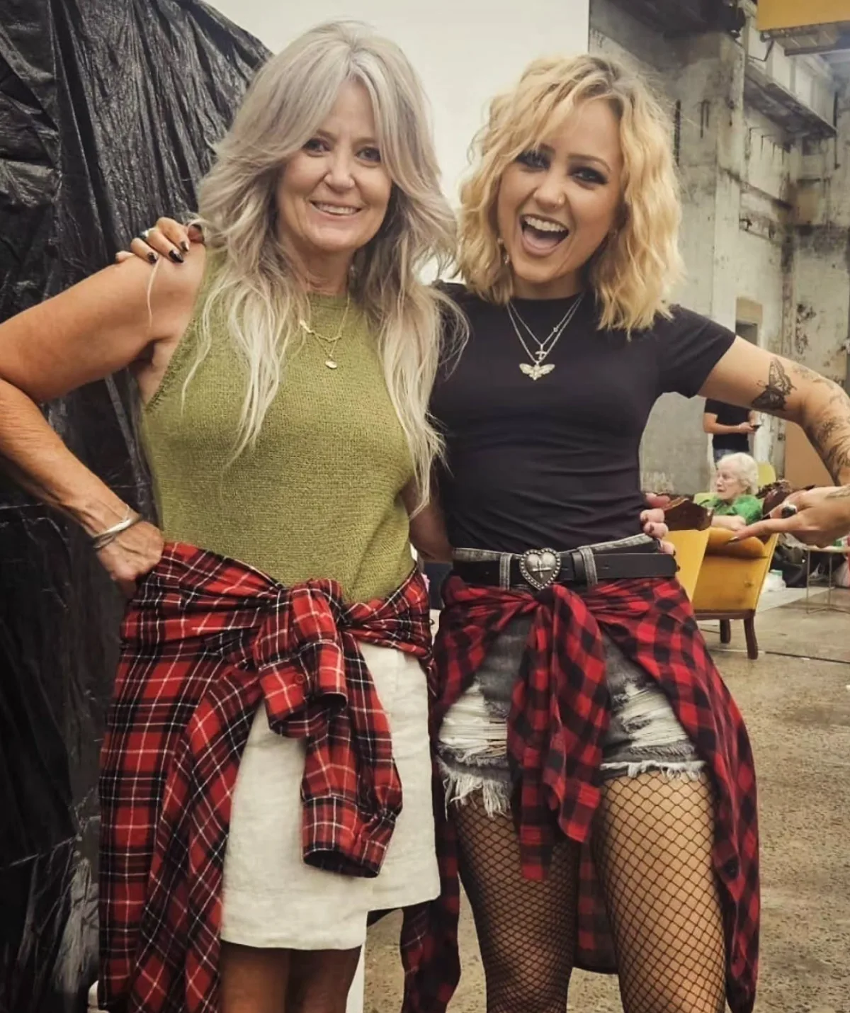 Tika and her mum stand with their arms around each other, both wearing flannelette shirts