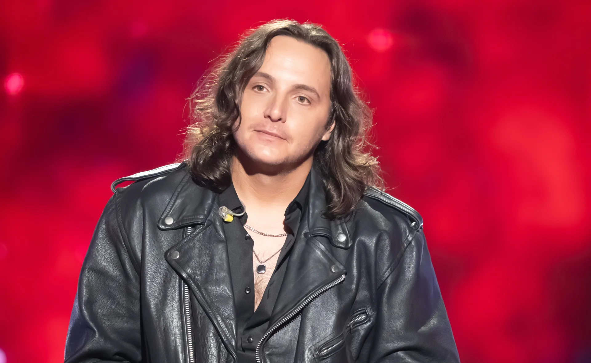 Jack, wearing a leather jacket, on the set of The Voice