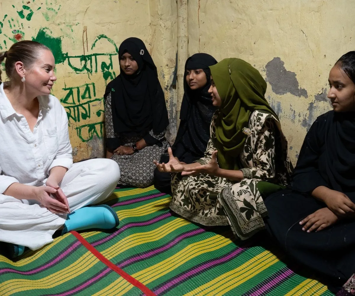 Jelena Dokic sitting with four young girls in Bangladesh