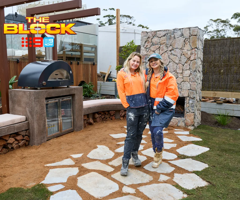 Courtney and Sev from The Block standing in their backyard.