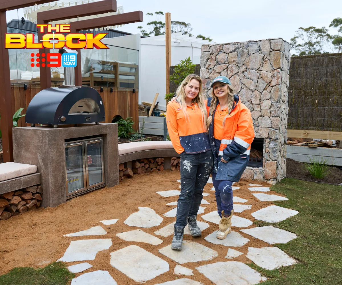 Courtney and Sev from The Block standing in their backyard.