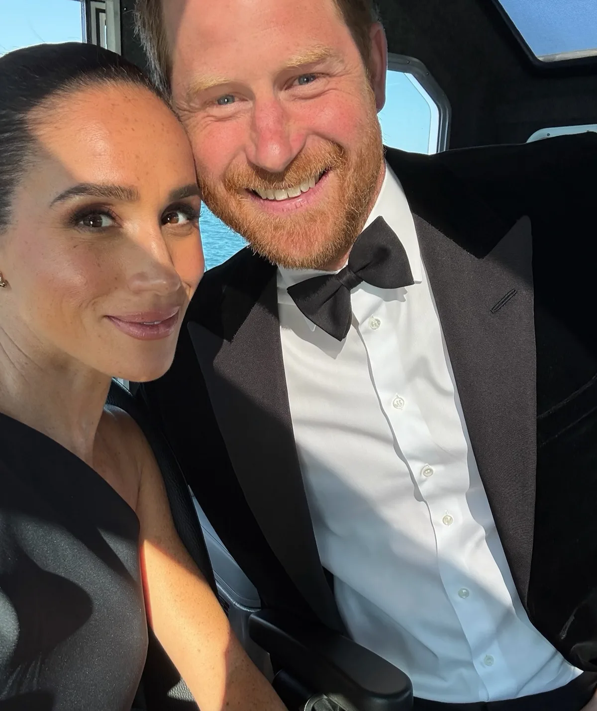 Meghan Markle and Prince Harry smile for the camera in a selfie 