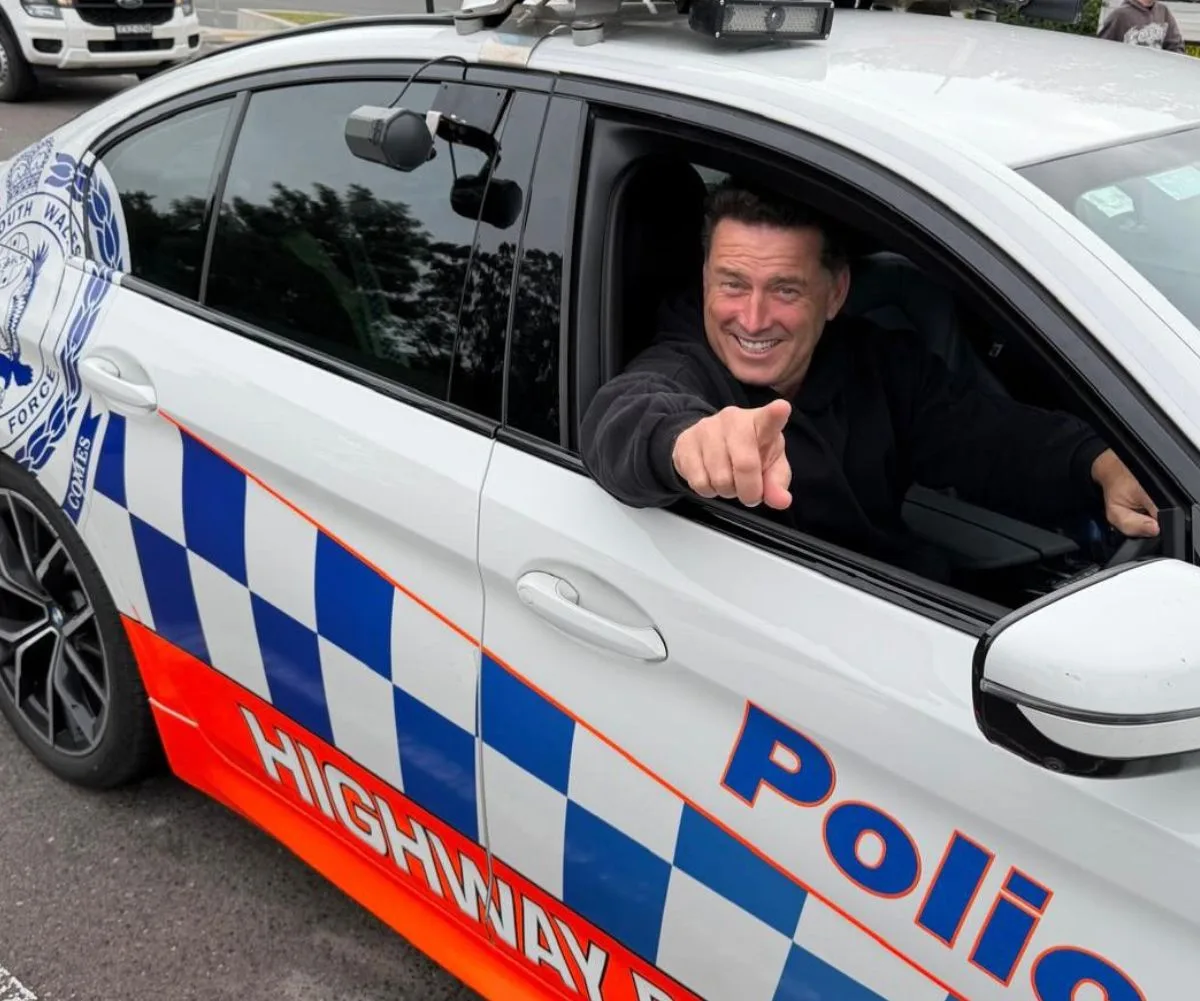 Karl Stefanovic in a police car