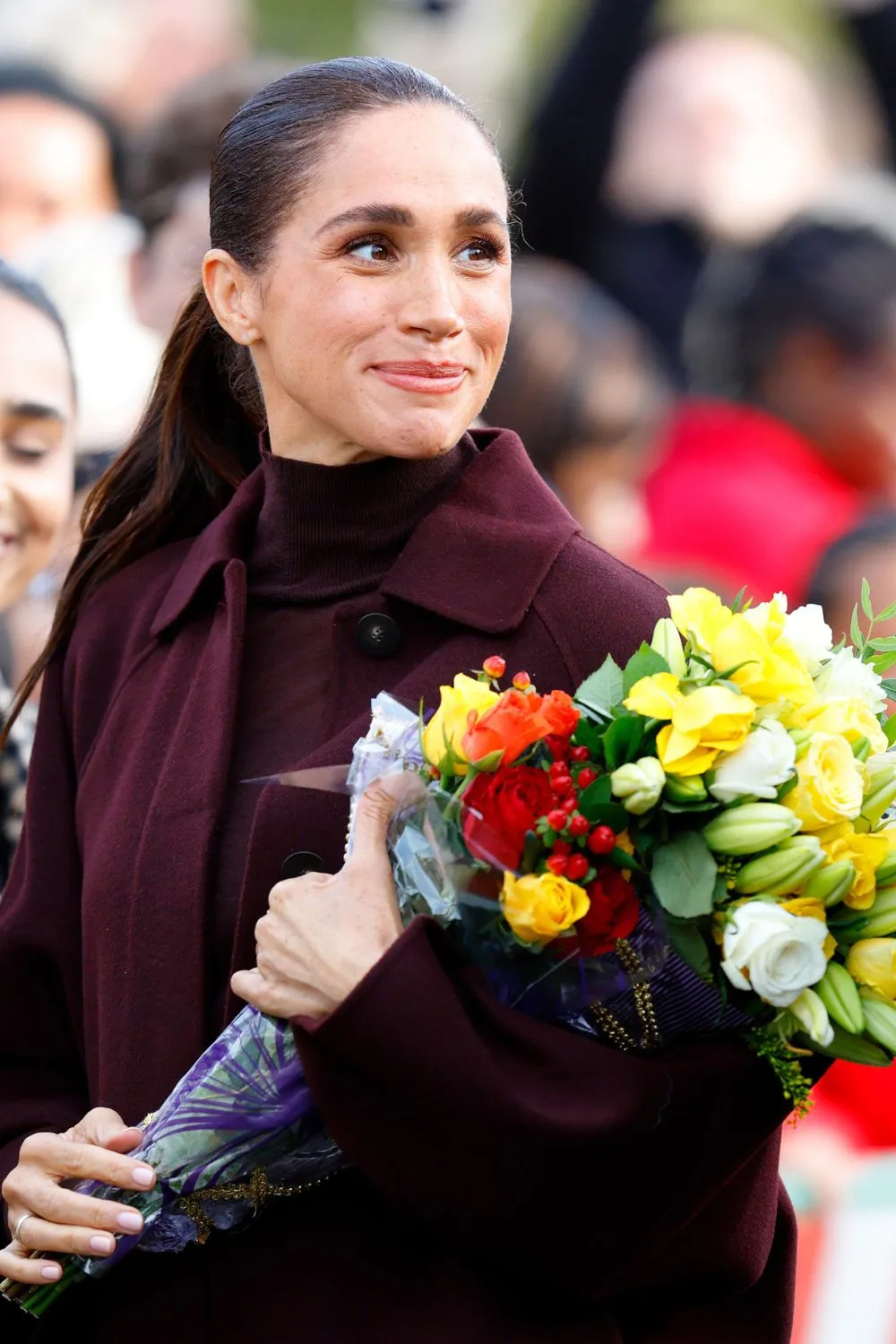 Meghan, Duchess of Sussex, holds a bunch of flowers