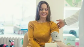 Woman getting blood pressure checked at pharmacy