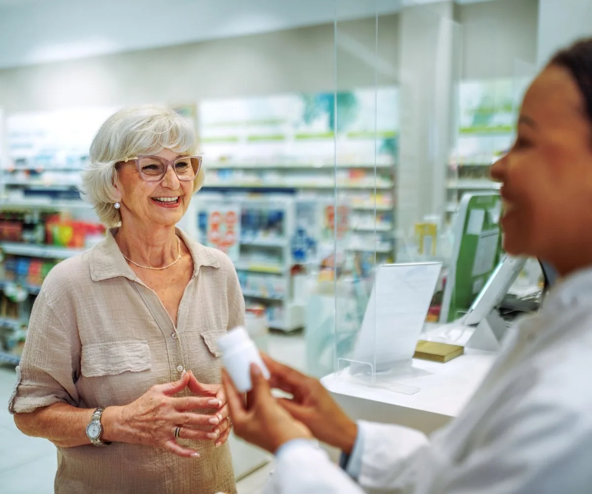 Older woman getting prescription filled at pharmacy