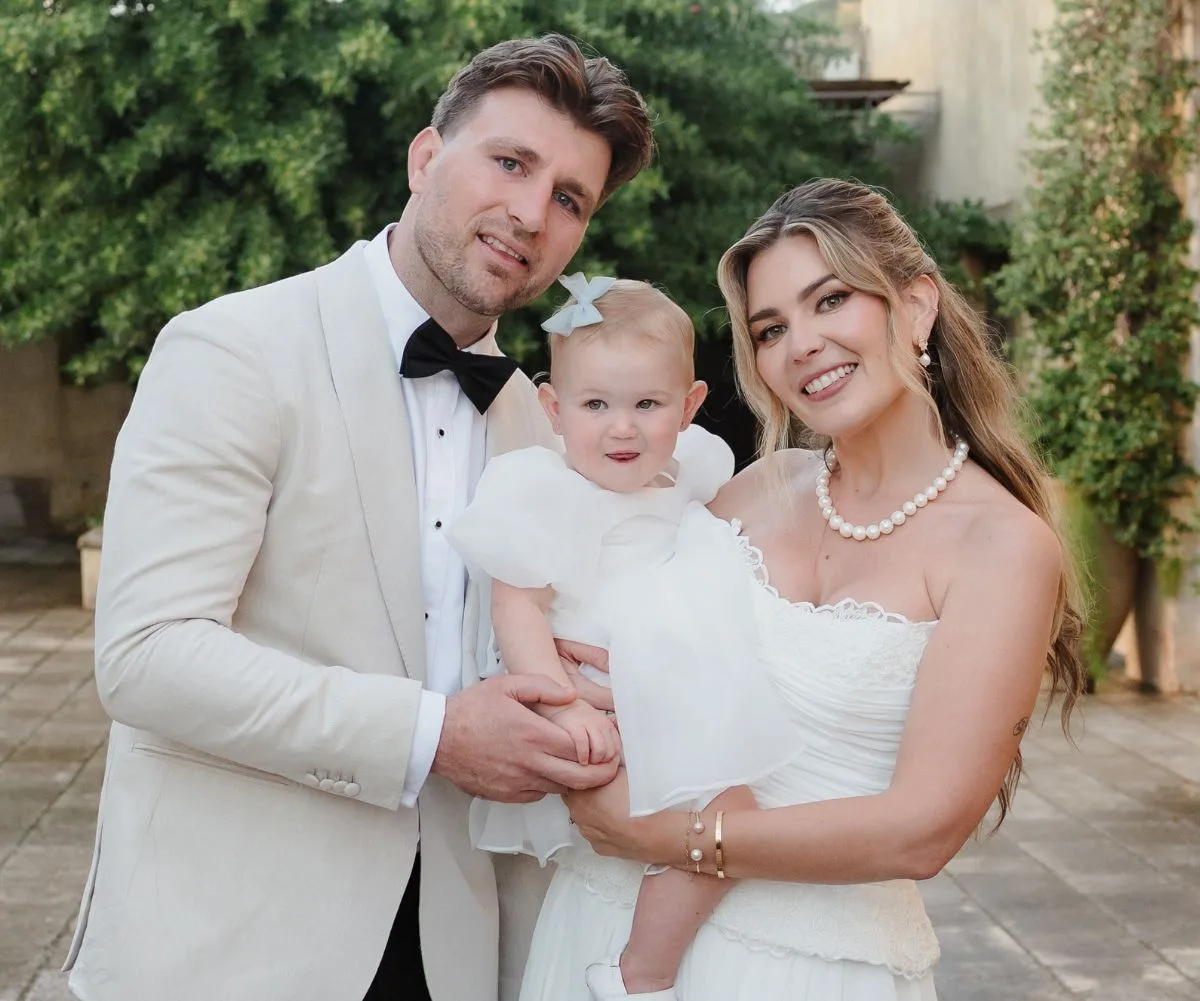 Jai Arrow with his wife and daughter at their wedding