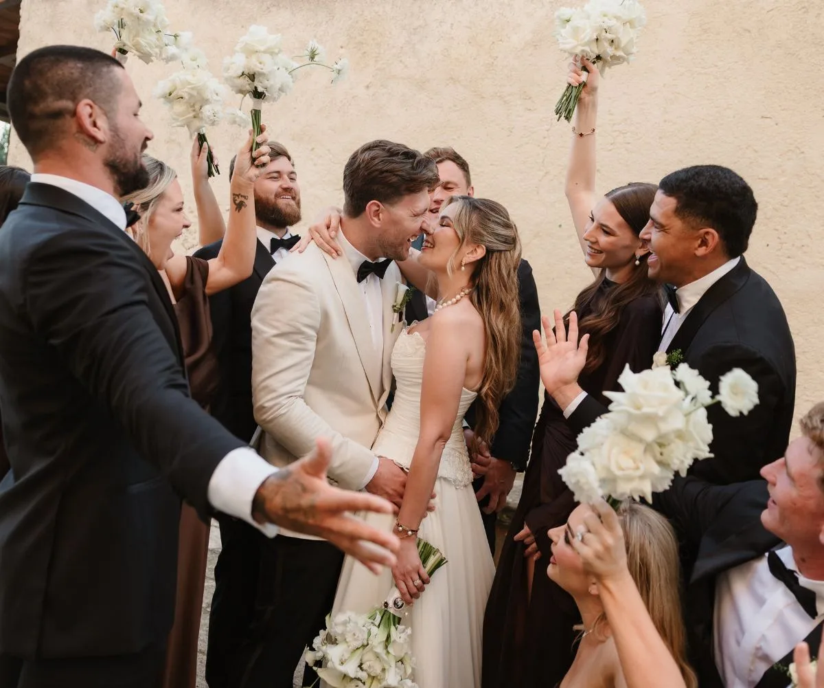 Jai Arrow and his wife with their bridal party on their wedding day