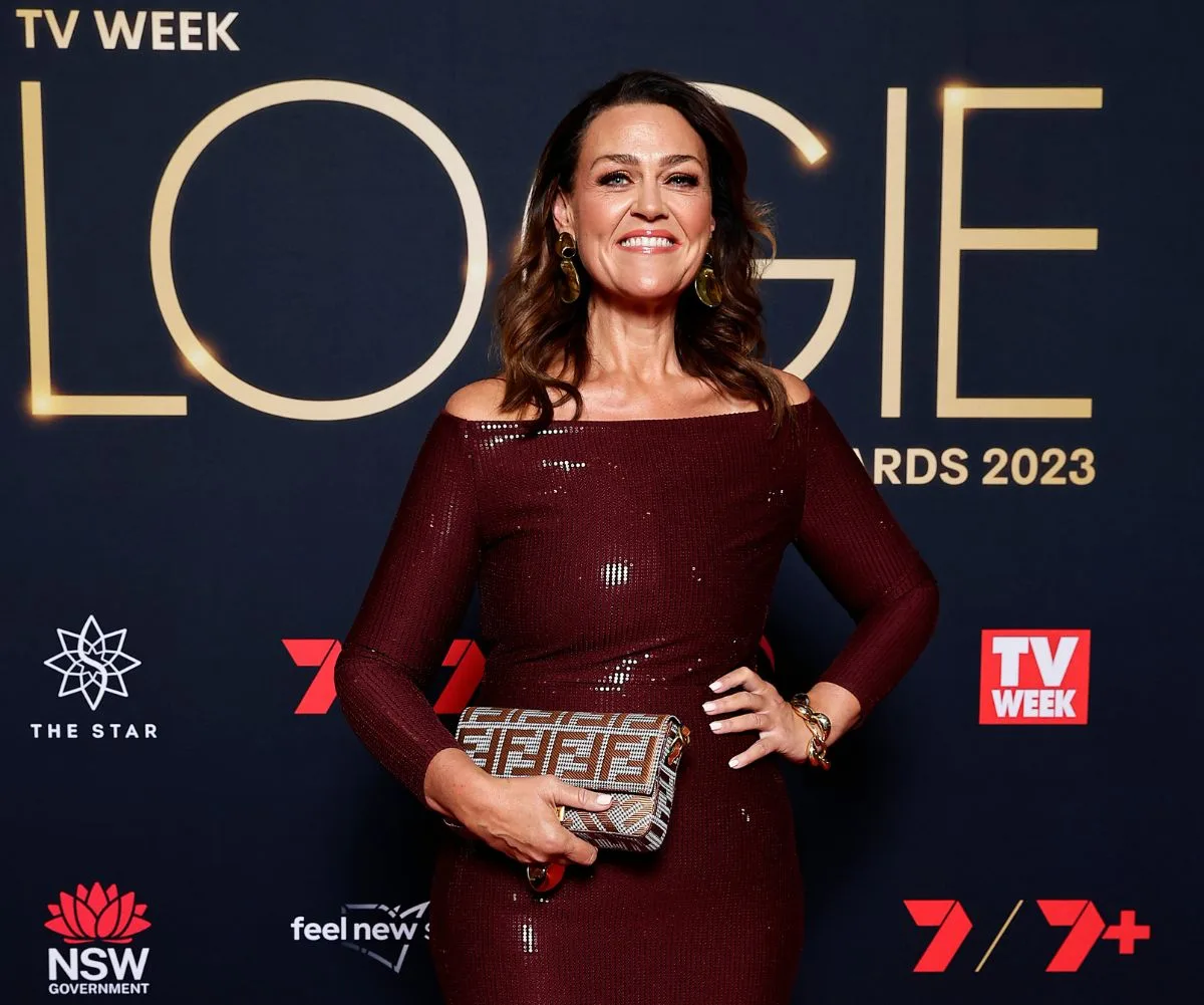 Chrissie Swan wearing maroon sparkly dress at the Logies