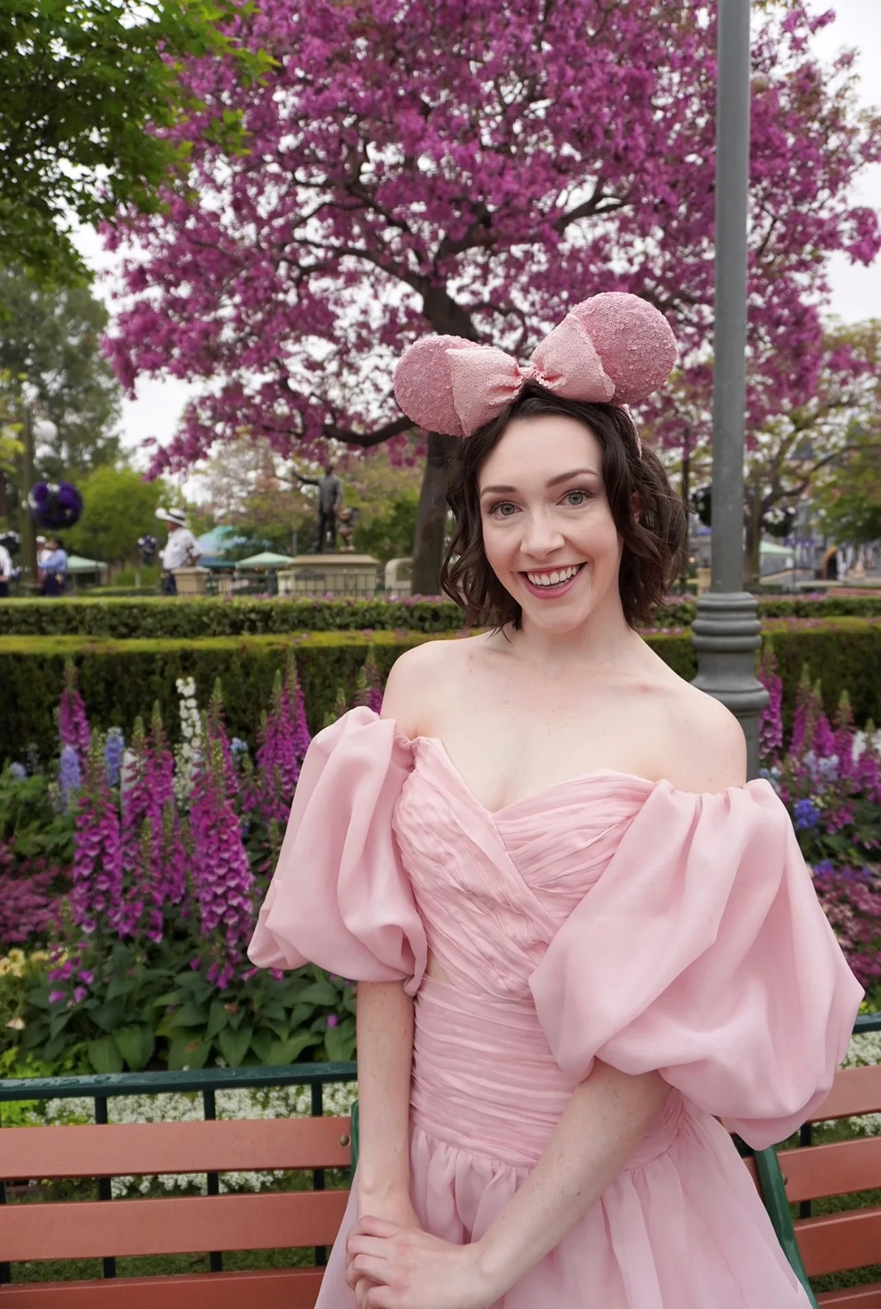 Delanie Jayne at Disneyland in pink mickey ears. 