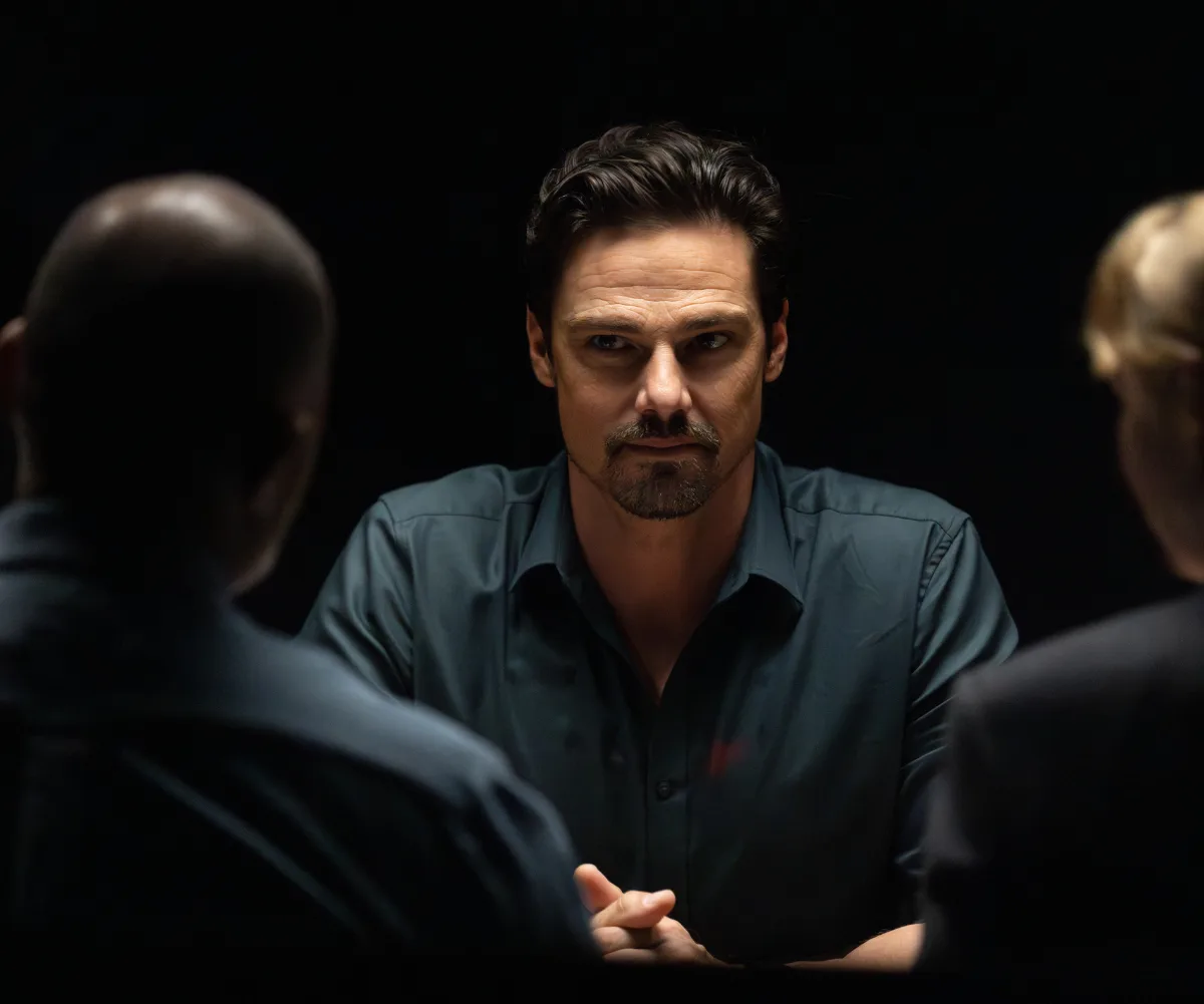 Jay Ryan, in a dark interview room on the set of Dustfall