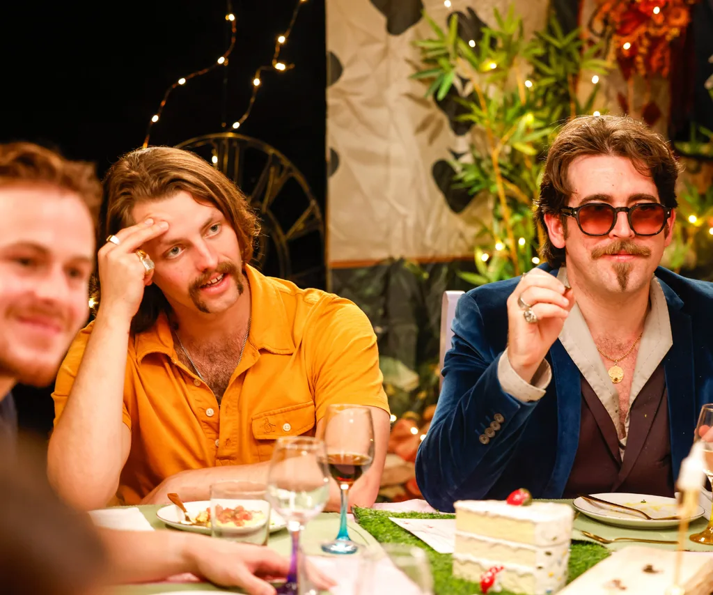 Harrison and Oliver sitting next to each other at the dinner table