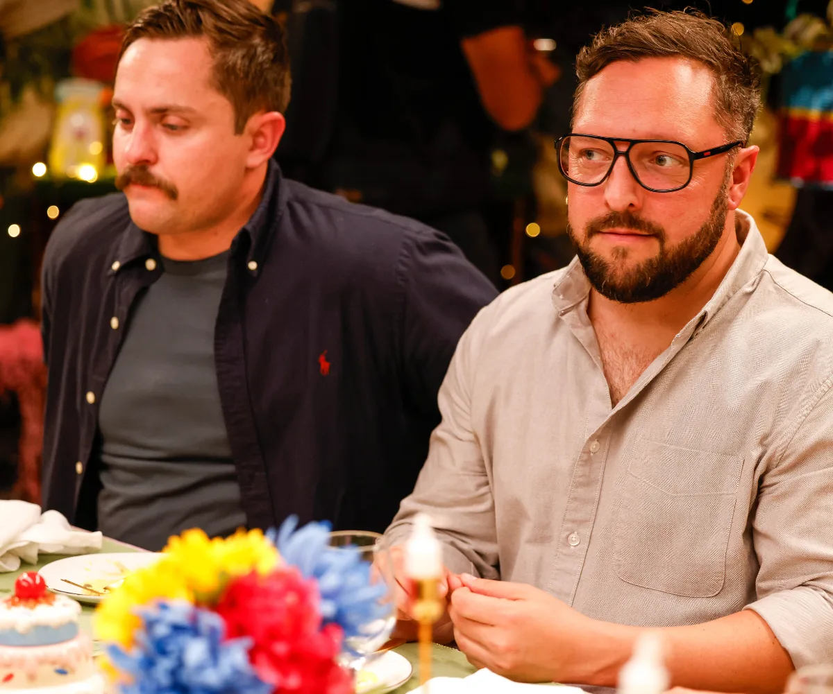 Angus and Simon sit next to each other at the dinner table