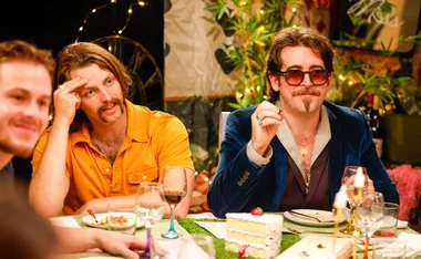 Harrison and Oliver sit next to each other at the dinner table