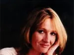 Author J.K. Rowling smiling, head resting on hand, dark background.
