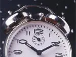 An analog alarm clock showing 10:10 against a dark, starry background.