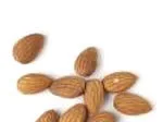 Almonds scattered on a white background.