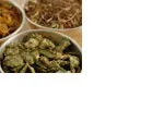 Bowls of various dried herbs and roots used for traditional medicinal purposes.