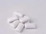Chewing gum pieces scattered on a plain white surface.
