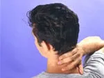 Man holding back of neck, possibly indicating discomfort or strain, against a light blue background.