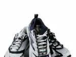 A pair of gray and black athletic shoes isolated on a white background.