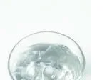 Glass of water with ice cubes on a white background.
