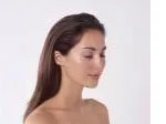 Profile of a calm woman with closed eyes, smooth skin, and long hair against a plain background.