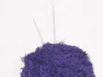 Purple fuzzy creature with two gray antennae sticking out from the top.