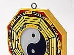 A Bagua mirror with a yin-yang symbol in the center, surrounded by trigrams, used in Feng Shui for protection.