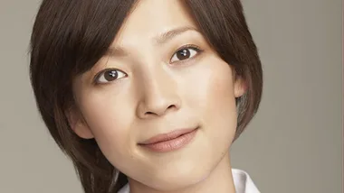 Alt text: "Portrait of a woman with short brown hair, looking into the camera with a neutral expression."