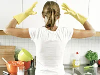 housewife in yellow gloves in kitchen