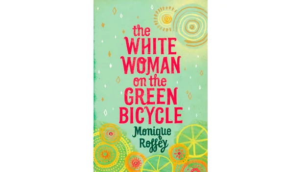 Book cover of "The White Woman on the Green Bicycle" by Monique Roffey, with abstract green and yellow circular patterns.