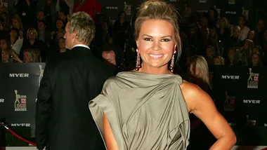 Sonia Kruger smiling in a glamorous dress at a red-carpet event.