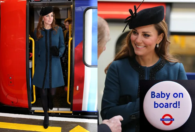 A woman with a "Baby on board!" badge steps off a train and smiles, wearing a teal coat and black hat.
