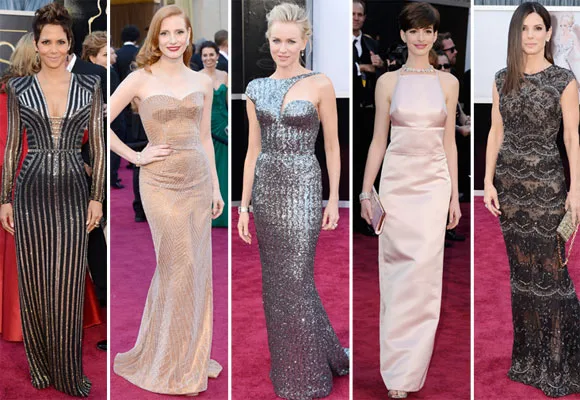 Five women in elegant gowns on the red carpet at the 2013 Academy Awards, showcasing diverse styles and colors.