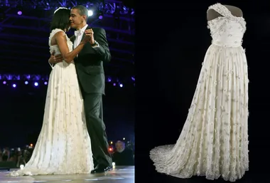 A couple dancing at an inaugural ball; a white one-shoulder gown with floral details displayed on the right.