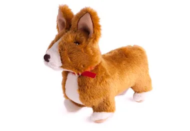 A plush toy corgi with brown and white fur, wearing a red ribbon collar, standing upright.